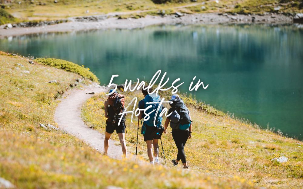 Hikers walking along the trail to Lake Chamol&eacute;, immersed in the alpine nature of Aosta.