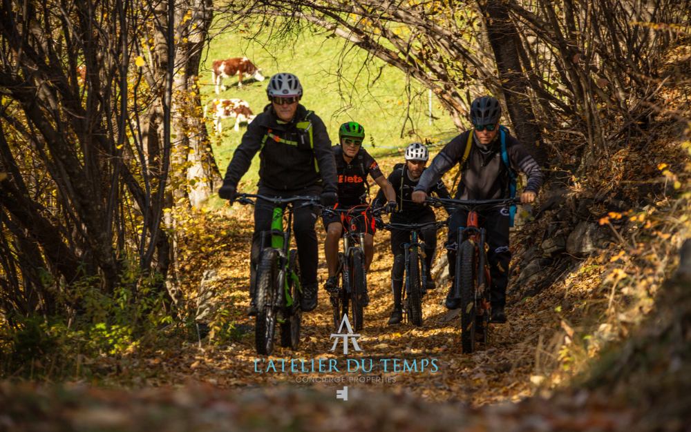 Bikers crossing a trail immersed in autumn colors