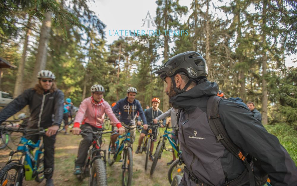 A group of bikers during a guided lesson in the woods of Aosta Valley.